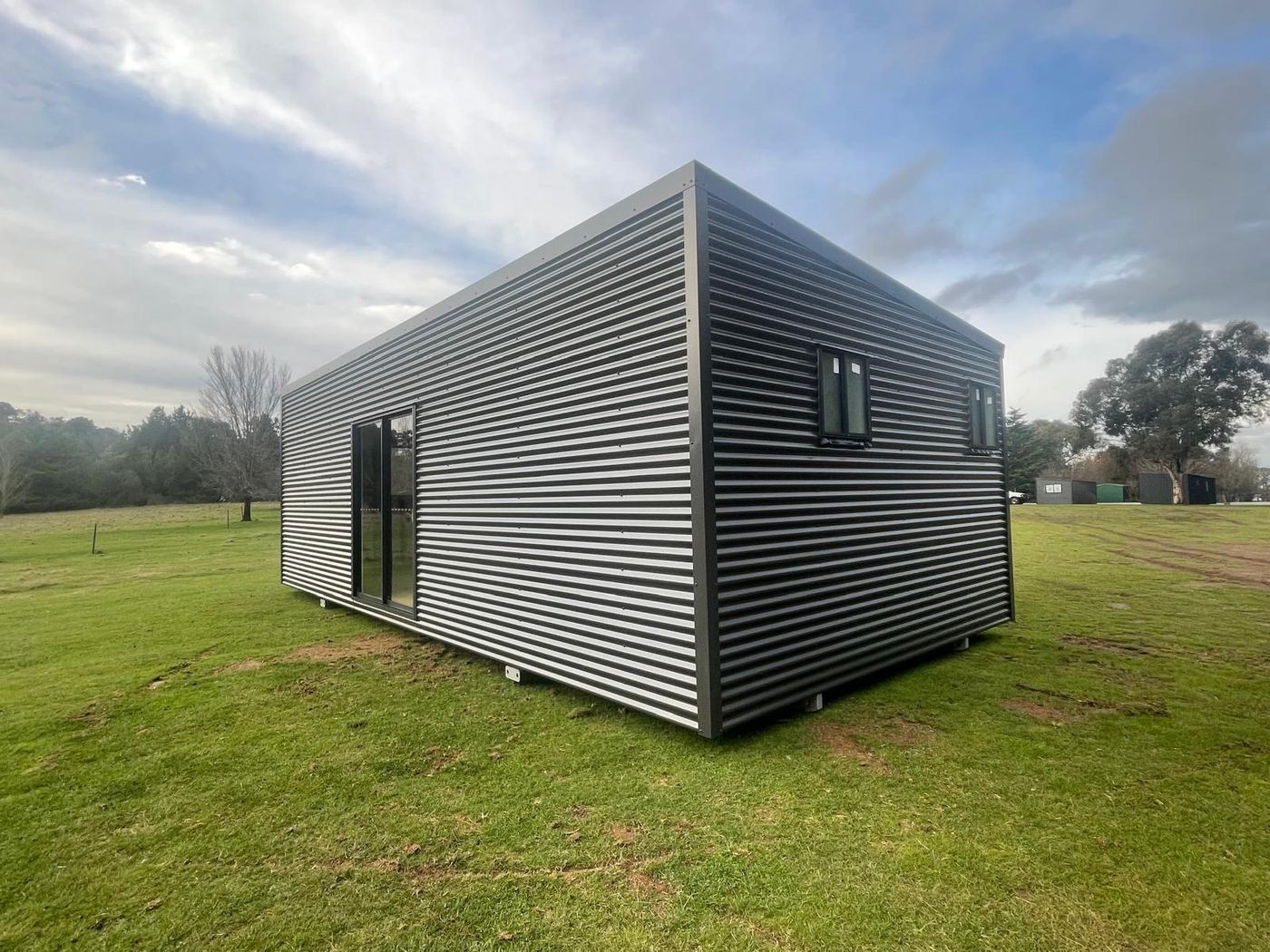 Corrugated steel cabin · sliding door in paddock